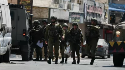 Israeli forces take part in a raid in Qalandia refugee camp, in the Israeli-occupied West Bank, August 6, 2026. REUTERS/Ammar Awad