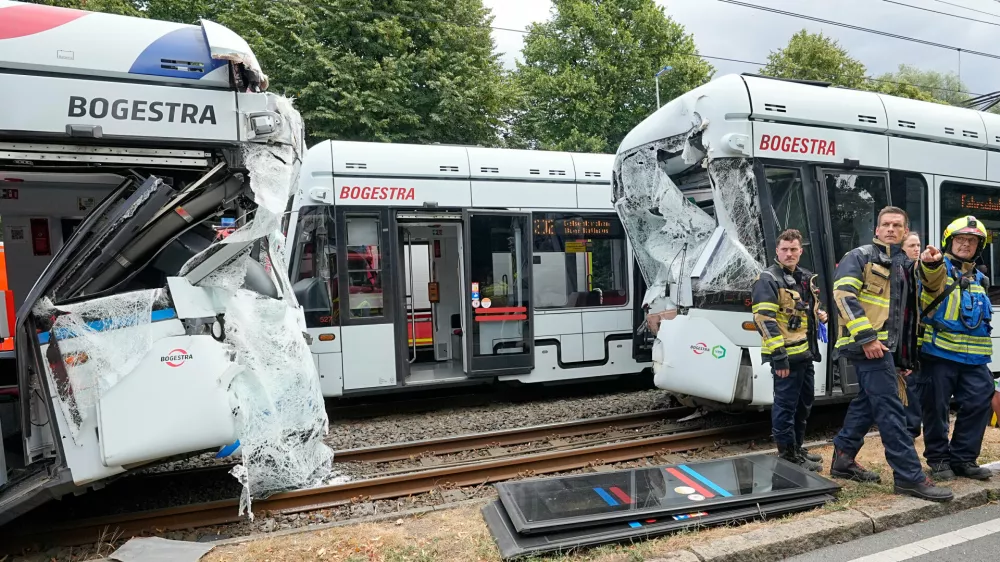 Emergency responders work at the scene of an accident where two trams collided in Gelsenkirchen, Germany, Thursday, Aug. 6, 2026. (AP Photo/Martin Meissner)