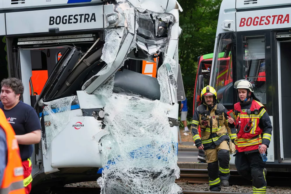 Emergency responders work at the scene of an accident where two trams collided in Gelsenkirchen, Germany, Thursday, Aug. 6, 2026. (AP Photo/Martin Meissner)