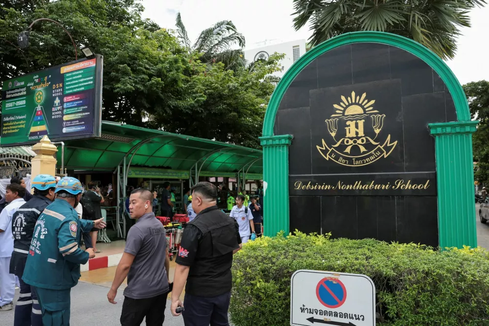 Emergency personnel stand outside Debsirin Nonthaburi School, the site of a shooting incident, in Bang Kruai district of Nonthaburi province on the outskirts of Bangkok, Thailand, August 7, 2026. REUTERS/Chalinee Thirasupa