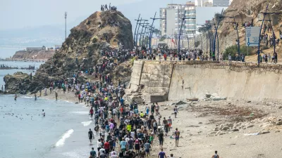 People walk on a beach after attempting to cross from the Moroccan northern town of Fnideq to the Spanish enclave of Ceuta, Friday, July 31, 2026. (AP Photo)