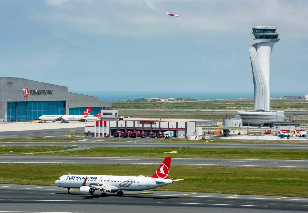 Istanbul, Turkey - June 3, 2023: Turkish Airlines airplane with Air Traffic Control Tower of Istanbul Airport. View of international Istanbul New Airport. / Foto: Resulmuslu