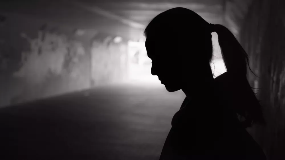Depressed sad young female standing in a dark tunnel / Foto: Kieferpix