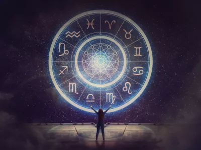 Woman raising hands looking at the night sky. Astrological wheel projection, choose a zodiac sign. Trust horoscope future predictions, consulting stars. Power of universe, astrology esoteric concept. / Foto: Bulat Silvia Getty Images