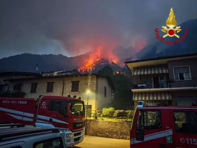 Fire engines stand near residential buildings as a wildfire burns on a hillside in Tignale, in the province of Brescia, Italy, in this handout image released on August 8, 2026. Vigili del Fuoco/Handout via REUTERS ATTENTION EDITORS &ndash; THIS IMAGE WAS PROVIDED BY A THIRD PARTY. LOGO FROM SOURCE. BEST QUALITY AVAILABLE.