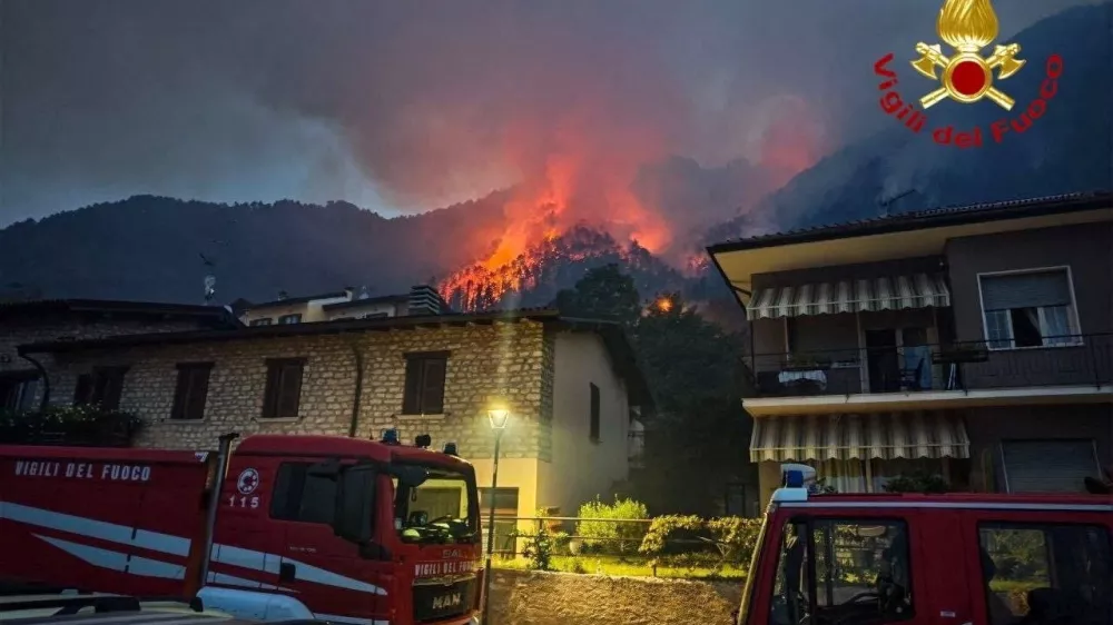 Fire engines stand near residential buildings as a wildfire burns on a hillside in Tignale, in the province of Brescia, Italy, in this handout image released on August 8, 2026. Vigili del Fuoco/Handout via REUTERS ATTENTION EDITORS &ndash; THIS IMAGE WAS PROVIDED BY A THIRD PARTY. LOGO FROM SOURCE. BEST QUALITY AVAILABLE.