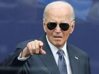 FILE PHOTO: Former U.S. President Joe Biden gestures during a dedication ceremony for the opening of the Obama Presidential Center, in Chicago, Illinois, U.S., June 18, 2026. REUTERS/Brendan McDermid/File Photo