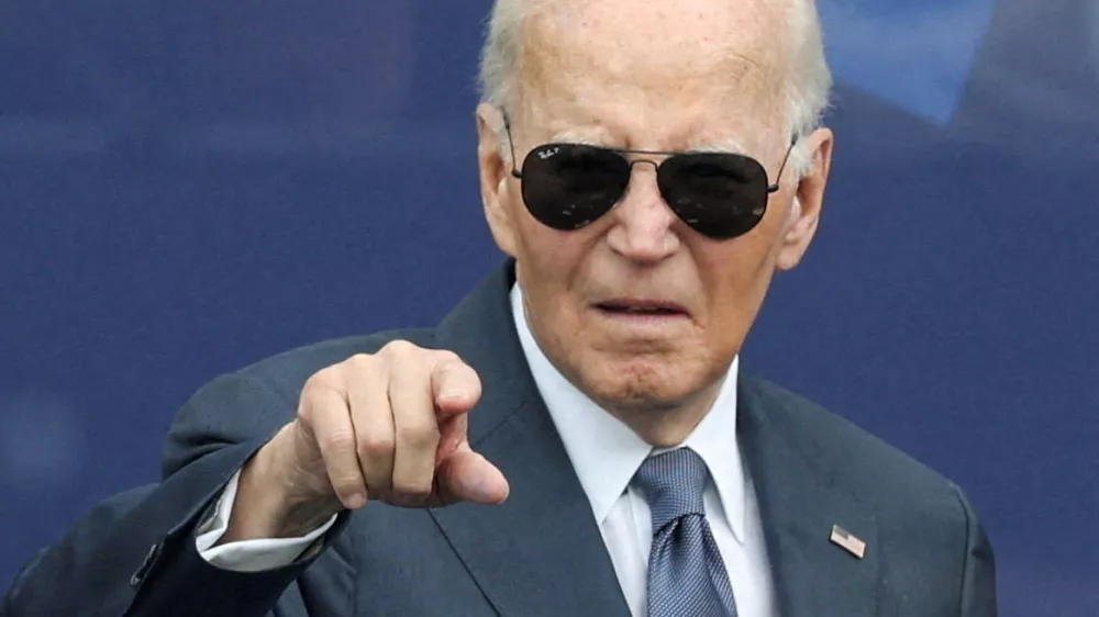 FILE PHOTO: Former U.S. President Joe Biden gestures during a dedication ceremony for the opening of the Obama Presidential Center, in Chicago, Illinois, U.S., June 18, 2026. REUTERS/Brendan McDermid/File Photo