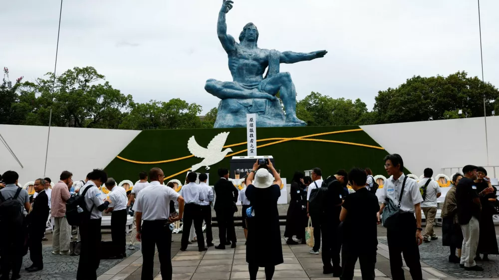 Attendees gather in front of the Nagasaki Peace Statue on the day of a ceremony commemorating the 81st anniversary of the bombing of Nagasaki at Nagasaki Peace Park in southwestern Japan, August 9, 2026. REUTERS/Manami Yamada