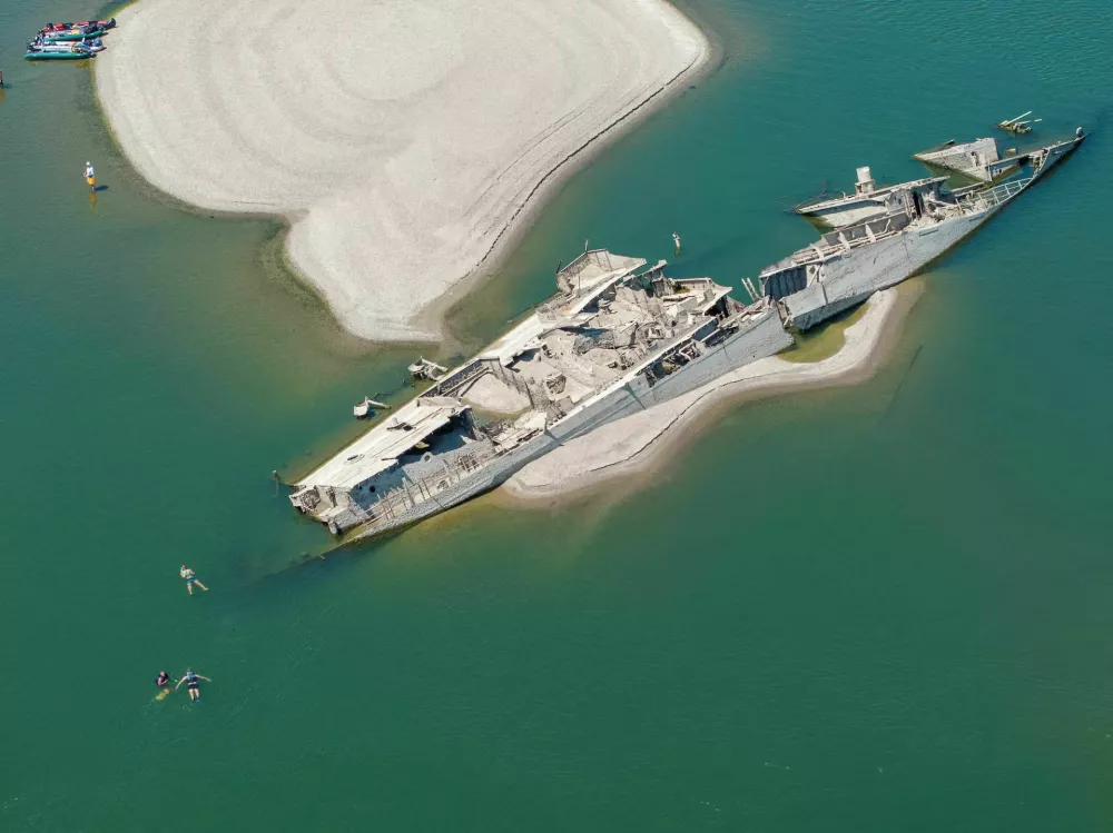 A drone view shows people swimming near a sunken German warship from World War II, exposed due to low Danube River levels caused by drought and extreme heat, in Prahovo, Serbia, July 30. REUTERS/Djordje Kojadinovic Purchase Licensing Rights