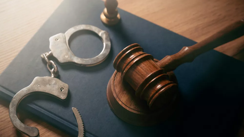 Handcuffs and wooden gavel. Crime, legal and violence concept.