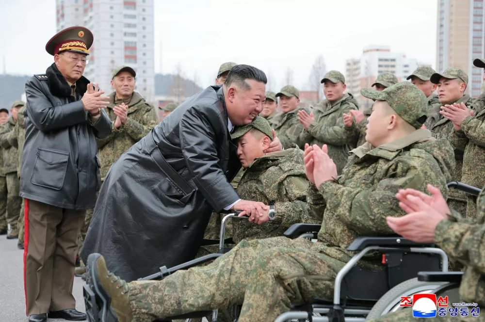 North Korean leader Kim Jong Un embraces a soldier during a welcoming ceremony for members of the 528th Engineer Regiment after they returned from an overseas mission, at the April 25 Cultural and Tourism Center in Pyongyang, North Korea, December 12, 2025, in this picture released by North Korea's official Korean Central News Agency on December 13, 2025. REUTERS/KCNA  KCNA via REUTERS  ATTENTION EDITORS - THIS IMAGE WAS PROVIDED BY A THIRD PARTY. REUTERS IS UNABLE TO INDEPENDENTLY VERIFY THIS IMAGE. NO THIRD PARTY SALES. SOUTH KOREA OUT. NO COMMERCIAL OR EDITORIAL SALES IN SOUTH KOREA.