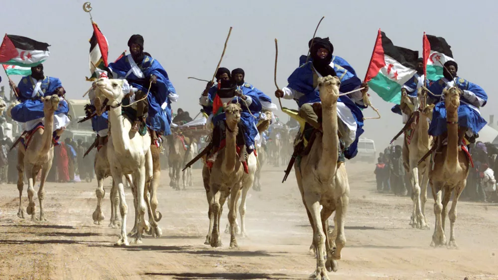 Sahrawi camel riders parade during celebrations for the 25th anniversary of the Polisario Front's independence movement for control of the Western Sahara from Morocco February 27, 2001 in the El Ayoun refugee camp in southwestern Algeria. Fifteen years of guerrilla war from 1976 to 1991, followed by a decade of international efforts to organize a referendum, have yet to settle the dispute over who the territory belongs to. REUTERS/Paul Hanna