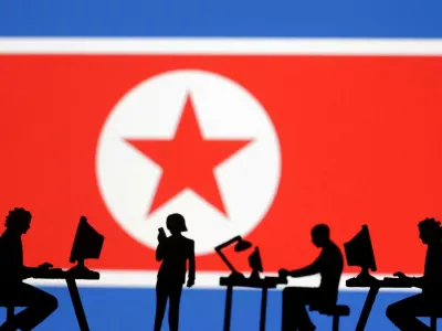 FILE PHOTO: Miniatures of people with computers are seen in front of North Korea flag in this illustration taken July 19, 2023. REUTERS/Dado Ruvic/Illustration/File Photo
