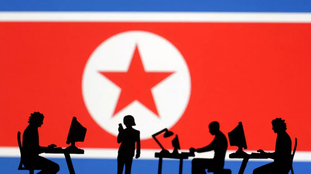 FILE PHOTO: Miniatures of people with computers are seen in front of North Korea flag in this illustration taken July 19, 2023. REUTERS/Dado Ruvic/Illustration/File Photo