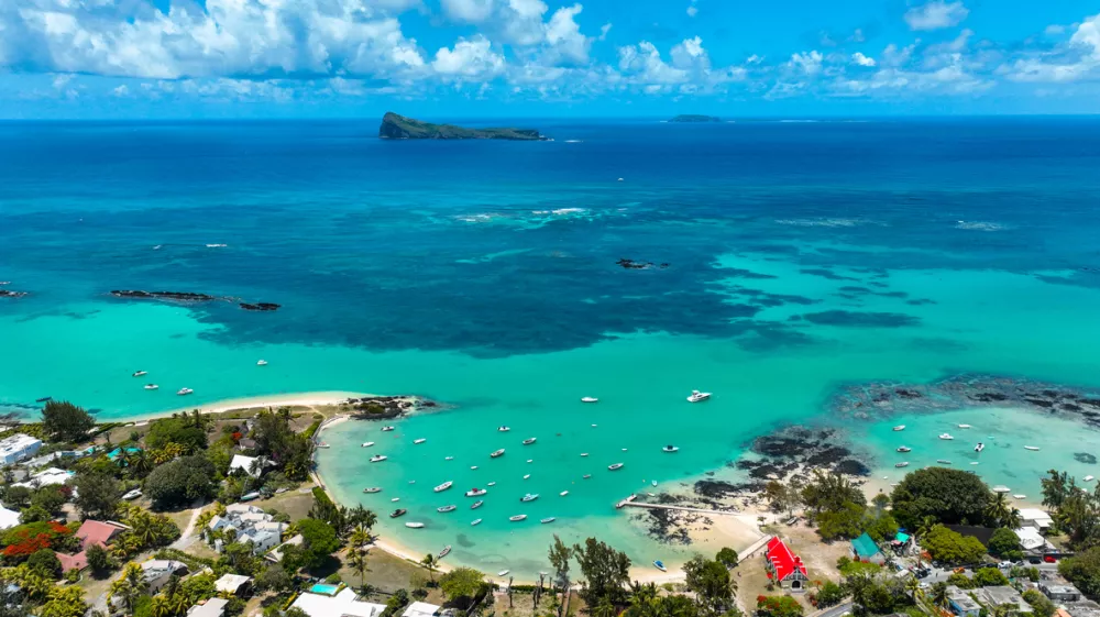 Aerial view of Cap Malheureux, Mauritius showing homes near vibrant reefs