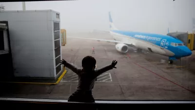 FILE - A child watches a plane at the Jorge Newbery airport in Buenos Aires, Argentina, April 14, 2016. (AP Photo/Natacha Pisarenko, File)