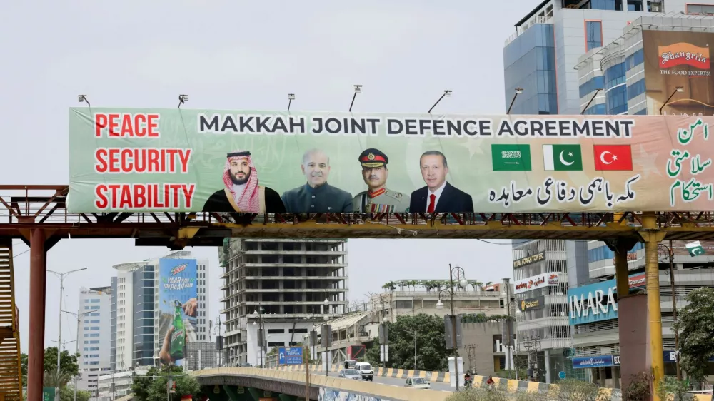 A billboard displays portraits of Saudi Crown Prince and Prime Minister Mohammed bin Salman, Pakistan's Prime Minister Muhammad Shehbaz Sharif, Pakistan's Chief of Defence Forces (CDF) and Chief of Army Staff, Field Marshal Asim Munir, and Turkish President Recep Tayyip Erdogan, following the signing of the Makkah Joint Defence Agreement, in Karachi, Pakistan, August 9, 2026. REUTERS/Akhtar Soomro