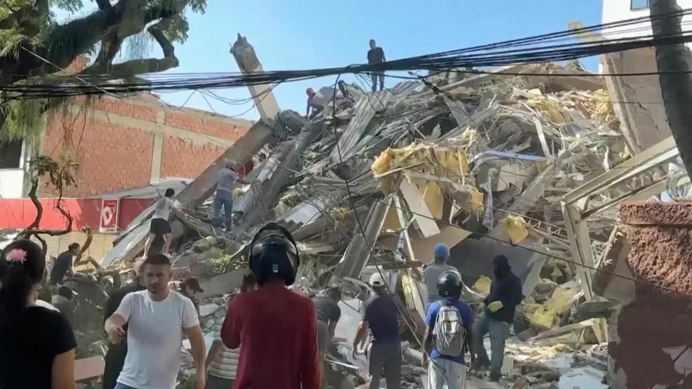 Rescue workers and residents stand around a collapsed building in the aftermath of an earthquake in Cali, Colombia, August 10, 2026 in this screengrab taken from a video. REUTERS/Reuters TV