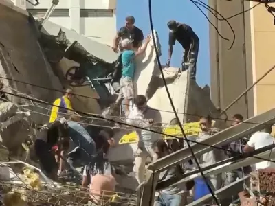 Rescue workers and residents stand atop a collapsed building in the aftermath of an earthquake in Cali, Colombia, August 10, 2026 in this screengrab taken from a video. REUTERS/Reuters TV