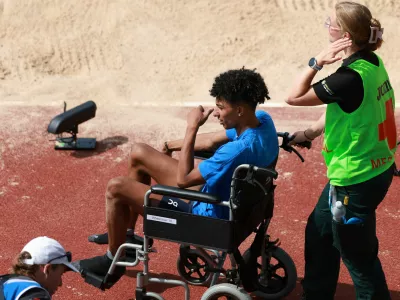 Italy's Mattia Furlani is taken away in a wheelchair after getting injured while competing in the men's long jump qualifying at the European Athletics Championships in Birmingham, England, Monday, Aug. 10, 2026. (AP Photo/Morgan Harlow)