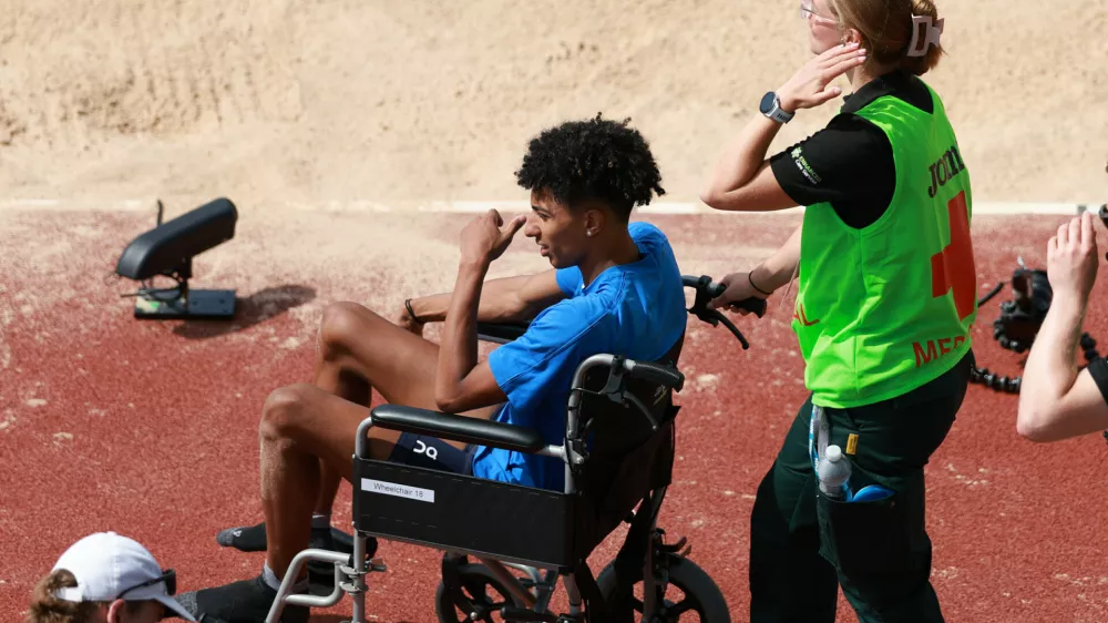 Italy's Mattia Furlani is taken away in a wheelchair after getting injured while competing in the men's long jump qualifying at the European Athletics Championships in Birmingham, England, Monday, Aug. 10, 2026. (AP Photo/Morgan Harlow)