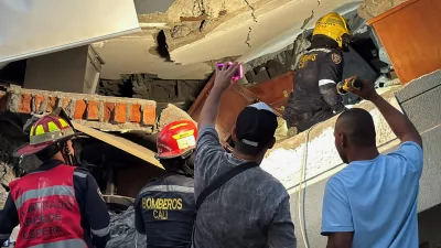Emergency personnel dig through debris at the site of a collapsed building as recovery efforts continue at night following an earthquake, in Cali, Colombia August 10, 2026. Picture taken with a mobile phone. REUTERS/Marco Trujillo