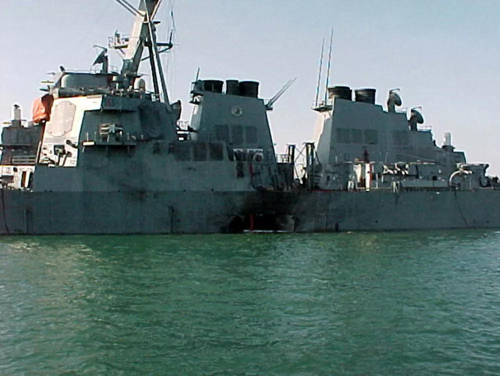 ** FILE ** In this photo provided by the U.S. Navy, shows damage sustained on the port side of the Arleigh Burke class guided missile destroyer USS Cole after a terrorist bomb exploded during a refueling operation in the port of Aden, Yemen, in a Thursday, Oct. 12, 2000 file photo. A federal judge on Wednesday, July 25, 2007, ordered the Republic of Sudan to pay nearly $8 million to the families of 17 sailors killed in the 2000 terrorist attack on the Navy's USS Cole. (AP Photo/U.S. Navy, File)