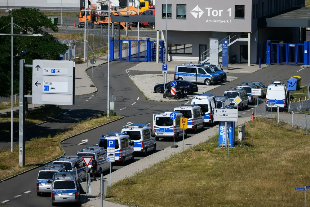 Police vehicles are parked at Leipzig/Halle Airport, where investigations are underway following the drone incident that occurred early Wednesday morning, in Schkeuditz, Germany, Thursday Aug. 6, 2026. (Hendrik Schmidt/dpa via AP)