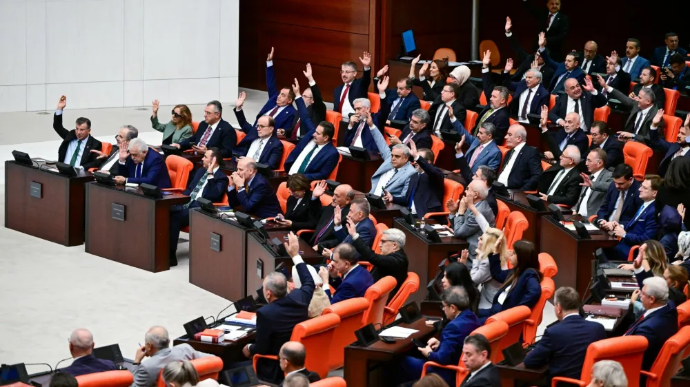 Lawmakers of the ruling AK Party (AKP) attend a voting session on a bill establishing a legal framework for the disbandment of the Kurdistan Workers Party (PKK) at the Turkish parliament in Ankara, Turkey, August 10, 2026. Parliament later passed the bill, a major step toward ending a conflict that has killed tens of thousands. REUTERS/Stringer TURKEY OUT. NO COMMERCIAL OR EDITORIAL SALES IN TURKEY.