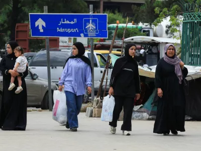 Women walk on a street as people make their way while fleeing the southern suburbs of Beirut, after Israeli Prime Minister Benjamin Netanyahu ordered the military to attack targets in the suburbs, Lebanon, June 1, 2026. REUTERS/Mohamed Azakir