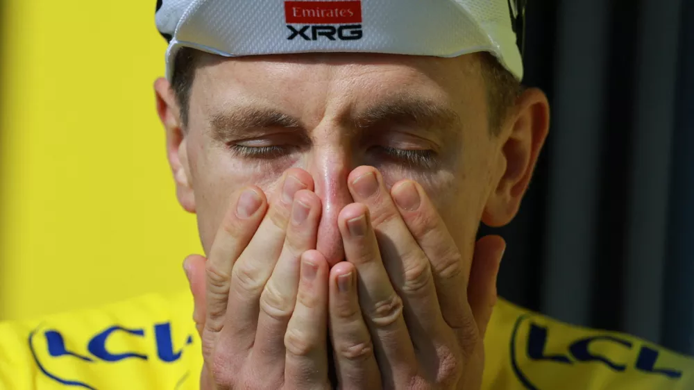 Cycling - Tour de France - Stage 15 - Champagnole to Plateau de Solaison - Plateau de Solaison, France - July 19, 2026 UAE Team Emirates XRG's Tadej Pogacar reacts on the podium wearing the yellow jersey after stage 15 REUTERS/Stephanie Lecocq