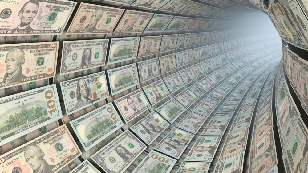 Symbolic image: Capital flow - Various US dollar bills as a flow of money / Foto: Designrage Getty Images