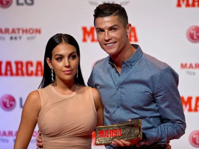 FILE - Juventus soccer player Cristiano Ronaldo poses with his partner, model Georgina Rodriguez in Madrid, July 29, 2019. (AP Photo/Paul White, File)