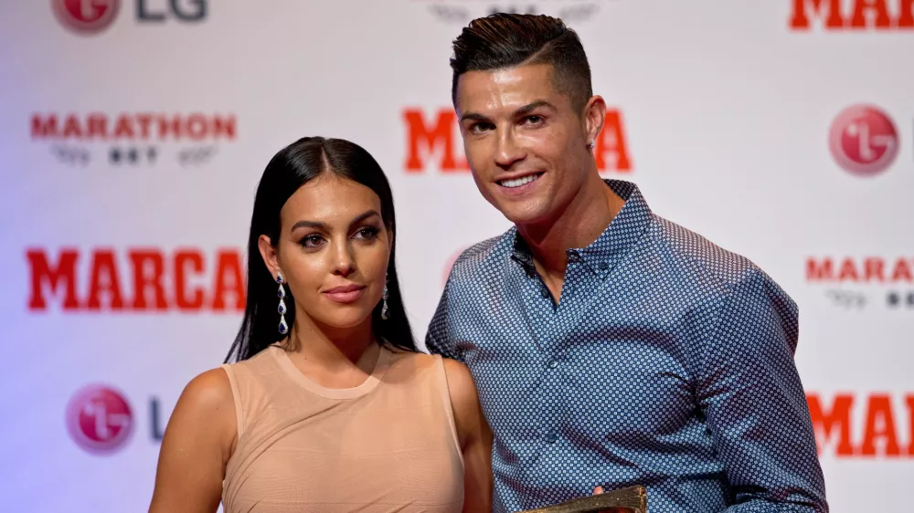 FILE - Juventus soccer player Cristiano Ronaldo poses with his partner, model Georgina Rodriguez in Madrid, July 29, 2019. (AP Photo/Paul White, File)