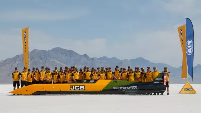 British driver Andy Green and the JCB engineering team pose with the car used to set a new land speed record for a hydrogen-powered vehicle, Tuesday, Aug. 11, 2026, at the Bonneville Salt Flats in Utah. (AP Photo/Hannah Schoenbaum)