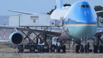 Catering trucks are parked at Air Force One on the tarmac as the motorcade carrying U.S. President Donald Trump arrives to depart following the NATO summit at Ankara International Airport in Ankara, Turkey, Wednesday, July 8, 2026. (AP Photo/Alex Brandon)
