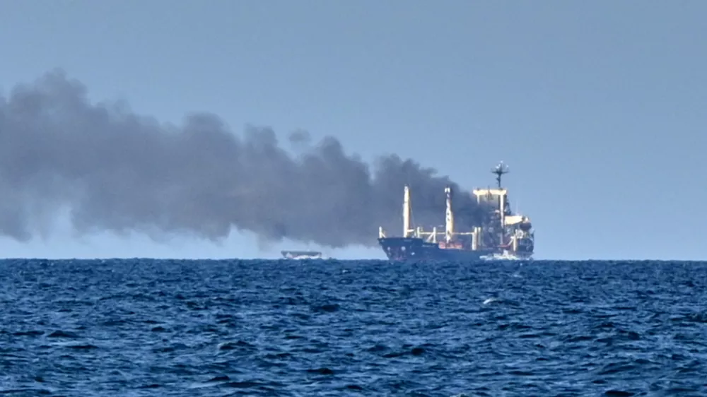 Smoke rises from the grain carrier Golden Leo&nbsp;under the Guinea-Bissau flag after Russian missile strike in the Black Sea close to Odesa, Ukraine, Sunday, July 19, 2026, local media reports. (AP Photo/Michael Shtekel)