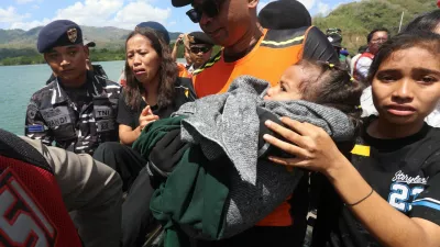 Passengers on board the KM Putri Yasmin, a ferry with around 130 people travelling from Bali that caught fire in waters off Lombok, react after being evacuated at Lembar port in Lombok, West Nusa Tenggara province, Indonesia, August 12, 2026. REUTERS/Stringer