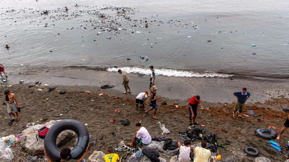Belongings left behind by migrants float in the sea after they crossed from Morocco into the Spanish enclave of Ceuta, Friday, July 31, 2026. (AP Photo/Antonio Sempere)