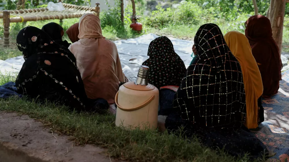 Women sit inside a tent while taking refuge with others following the deadly earthquake in Bambakot village, Dera Noor district, Nangarhar province, Afghanistan, September 6, 2025. REUTERS/Sayed Hassib