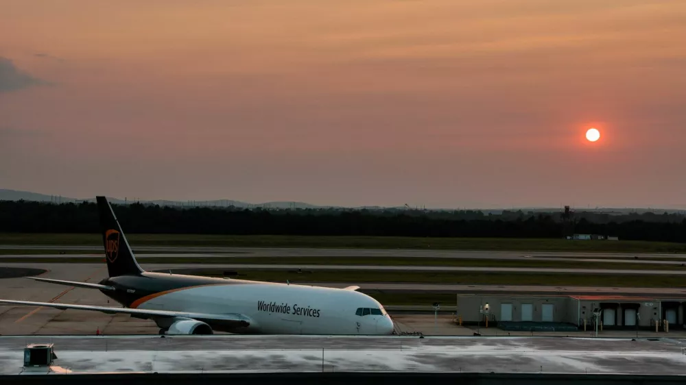 The sun sets behind a UPS plane at Washington Dulles International Airport, which U.S. President Donald Trump has proposed a $22 billion renovation plan, in Dulles, Virginia, U.S., August 9, 2026. REUTERS/Kylie Cooper