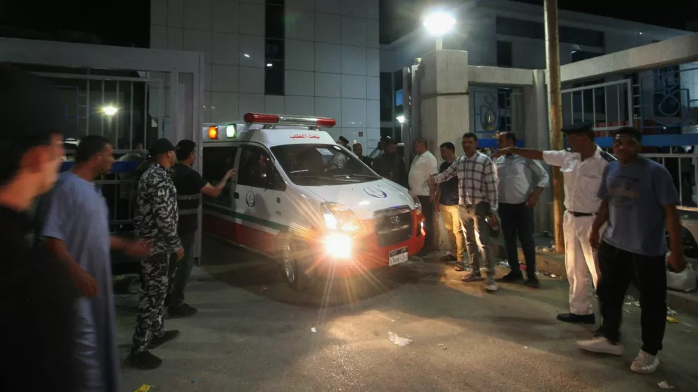 Families of Egyptian workers killed in a road accident surround an ambulance, as ambulances carry bodies of their loved ones, outside Al Qasasin Specialized Hospital in Ismailia, Egypt, August 11, 2026. Several people were killed, and others were injured when two pickup trucks carrying workers collided in Egypt's Ismailia Governorate, the Health Ministry said. REUTERS/Shokry Hussein