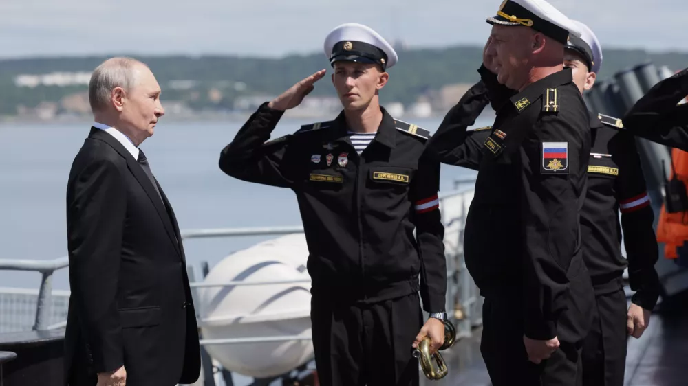 Russian President Vladimir Putin, left, visits the Varyag missile cruiser of the Pacific Fleet to watch a military exercise near Yuzhno-Sakhalinsk, on Sakhalin Island, Russia, Wednesday, Aug. 12, 2026. (Gavriil Grigorov, Sputnik, Kremlin Pool Photo via AP)