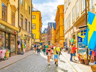 Stockholm, Sweden - 19 May, 2024: Popular shopping street V&auml;sterl&aring;nggatan in Stockholm old town, Gamla Stan district. People walking down the street.