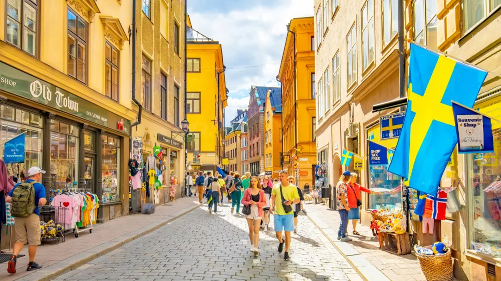 Stockholm, Sweden - 19 May, 2024: Popular shopping street V&auml;sterl&aring;nggatan in Stockholm old town, Gamla Stan district. People walking down the street.