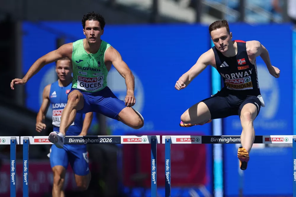 Athletics - European Athletics Championships - Alexander Stadium, Birmingham, Britain - August 12, 2026 Norway's Karsten Warholm and Slovenia's Matic Ian Gucek in action during the men's 400m hurdles semi final 3 REUTERS/Andrew Boyers