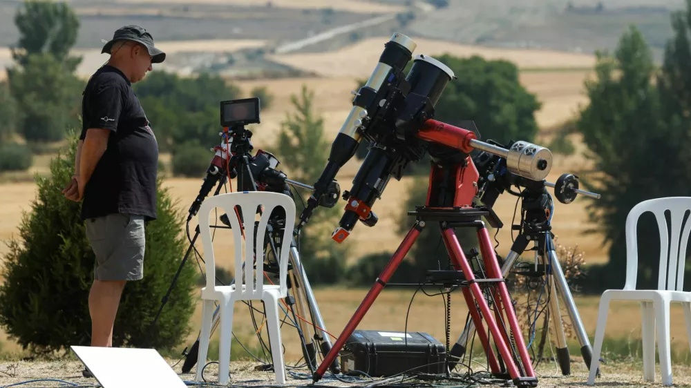 A member of the Exploratorium team, a science, technology and arts museum in San Francisco, stands by telescopes as he prepares to observe a solar eclipse in Villalibado, Spain, August 12, 2026. REUTERS/Jon Nazca