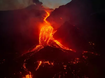 A drone view shows molten lava flowing down the slope during an eruption at Mount Etna in Sicily, Italy, August 11, 2026. Giuseppe Di Stefano/Etna Walk/via REUTERS  ATTENTION EDITORS - THIS IMAGE WAS PROVIDED BY A THIRD PARTY.   TPX IMAGES OF THE DAY