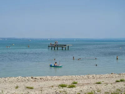 Bodensee: Badeg&auml;ste und Wassersportler genie&szlig;en einen sonnigen Sommertag im Bodensee. Menschen schwimmen im See, fahren mit Schlauchboot und Stand-up-Paddle weitere Personen stehen auf einem Badesteg. Im Hintergrund Segelboote und das gegen&uuml;berliegende Ufer. Sommer, Hitze, Freizeit, Baden, Schwimmen, Wassersport, Tourismus, Ferien, Erholung, See, Strand, Badesteg, SUP, Panorama, Totale, Symbolbild. *** Lake Constance: Swimmers and water sports enthusiasts enjoy a sunny summer day on Lake Constance. People are swimming in the lake, riding in inflatable boats, and stand-up paddleboarding others are standing on a swimming dock. In the background are sailboats and the opposite shore. Summer, heat, leisure, swimming, water sports, touri Copyright: xJOERANxSTEINSIEKx,Image: 1122385421, License: Rights-managed, Restrictions: imago is entitled to issue a simple usage license at the time of provision. Personality and trademark rights as well as copyright laws regarding art-works shown must be observed. Commercial use at your own risk., Model Release: no 
